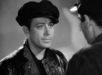 Movie still from “Spawn of the North” (1938), directed by Henry Hathaway – A black and white photo of a man wearing a hat; Close Up shot, Over the shoulder angle