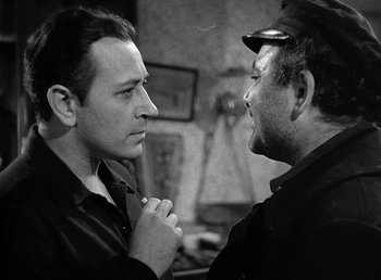 Movie still from “Spawn of the North” (1938), directed by Henry Hathaway – Two men are talking to each other in a room; Close Up shot, Over the shoulder angle