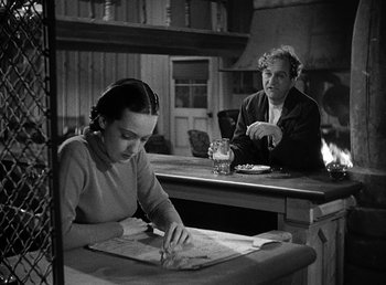 Movie still from “Spawn of the North” (1938), directed by Henry Hathaway – A woman sitting at a table in front of another woman; Medium shot, High angle