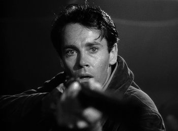 Movie still from “Spawn of the North” (1938), directed by Henry Hathaway – Black and white photograph of a man holding a gun; Close Up shot, Low angle