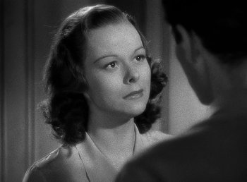 Movie still from “Spawn of the North” (1938), directed by Henry Hathaway – A woman looking into a mirror in a black and white photo; Close Up shot, Over the shoulder angle