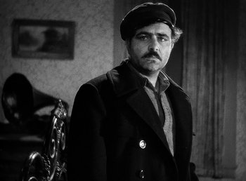 Movie still from “Spawn of the North” (1938), directed by Henry Hathaway – A black and white photo of a man wearing a hat; Close Up shot, Low angle