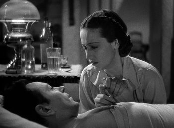 Movie still from “Spawn of the North” (1938), directed by Henry Hathaway – A woman sitting next to a man on a bed; Close Up shot, High angle