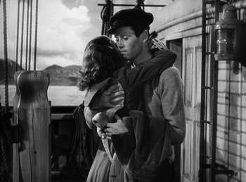 Movie still from “Spawn of the North” (1938), directed by Henry Hathaway – A man and a woman standing next to each other on a boat; Medium shot, Low angle