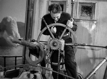 Movie still from “Spawn of the North” (1938), directed by Henry Hathaway – A black and white photo of a man working on a boat; Medium shot, High angle