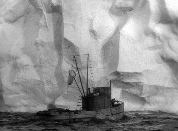 Movie still from “Spawn of the North” (1938), directed by Henry Hathaway – An old fishing boat in the middle of the ocean; Extreme Wide shot, High angle