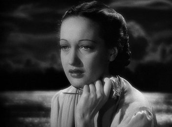 Movie still from “Spawn of the North” (1938), directed by Henry Hathaway – A black - and - white photo of a woman with a flower in her hand; Close Up shot, High angle