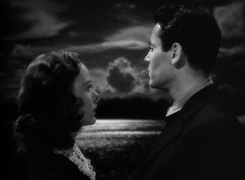 Movie still from “Spawn of the North” (1938), directed by Henry Hathaway – A man and a woman standing next to each other in front of a body of water; Close Up shot, High angle