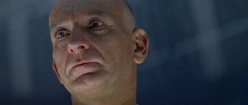 Movie still from “Species” (1995), directed by Roger Donaldson – A man's face looking up at the sky; Extreme Close Up shot, Low angle