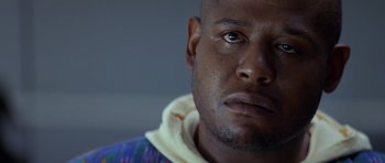 Movie still from “Species” (1995), directed by Roger Donaldson – A man's face in a blue shirt; Close Up shot, Low angle
