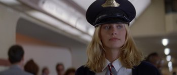 Movie still from “Species” (1995), directed by Roger Donaldson – A woman wearing a uniform and a hat; Close Up shot, Low angle