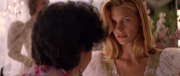 Movie still from “Species” (1995), directed by Roger Donaldson – A woman in a white dress looking at another woman in a white dress; Close Up shot, Over the shoulder angle