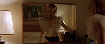 Movie still from “Species” (1995), directed by Roger Donaldson – A woman in a white dress standing in front of a mirror; Medium shot, Low angle