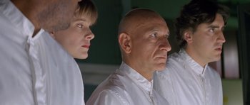 Movie still from “Species” (1995), directed by Roger Donaldson – A man and a boy in white shirts looking at something; Close Up shot, Low angle