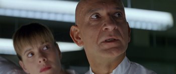 Movie still from “Species” (1995), directed by Roger Donaldson – A man with a bald head looking up; Close Up shot, Low angle
