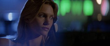 Movie still from “Species” (1995), directed by Roger Donaldson – A woman with headphones looking into the distance; Close Up shot, Low angle