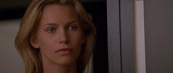 Movie still from “Species” (1995), directed by Roger Donaldson – A woman's face in front of a window; Close Up shot, Low angle