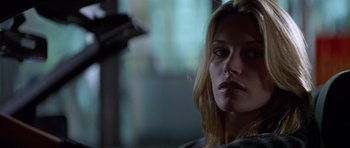Movie still from “Species” (1995), directed by Roger Donaldson – A person with long blonde hair; Close Up shot, Low angle