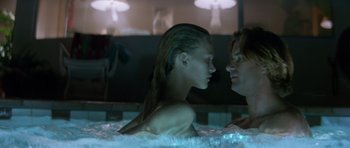 Movie still from “Species” (1995), directed by Roger Donaldson – A man and a woman in a hot tub at night; Close Up shot, Low angle