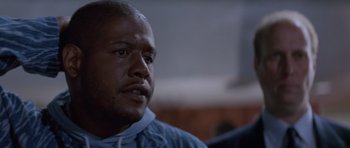 Movie still from “Species” (1995), directed by Roger Donaldson – An older man is looking into the distance; Close Up shot, Low angle