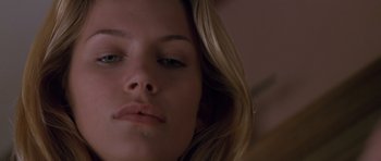 Movie still from “Species” (1995), directed by Roger Donaldson – A young woman's face with long blonde hair; Close Up shot, Low angle
