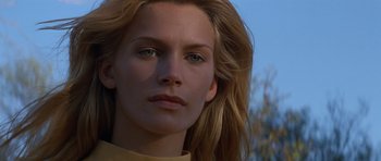 Movie still from “Species” (1995), directed by Roger Donaldson – A woman's face with long blonde hair; Close Up shot, Low angle