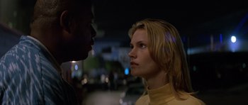 Movie still from “Species” (1995), directed by Roger Donaldson – A man and a woman face to face in the dark; Close Up shot, Low angle