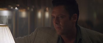 Movie still from “Species” (1995), directed by Roger Donaldson – A person sitting in a chair; Close Up shot, Low angle