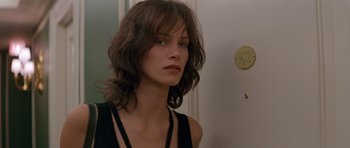 Movie still from “Species” (1995), directed by Roger Donaldson – A person with long brown hair; Close Up shot, Over the shoulder angle