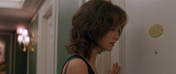 Movie still from “Species” (1995), directed by Roger Donaldson – A person standing in front of a mirror; Close Up shot, Over the shoulder angle