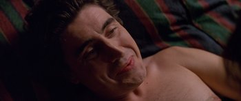 Movie still from “Species” (1995), directed by Roger Donaldson – A person laying on a bed; Close Up shot, High angle