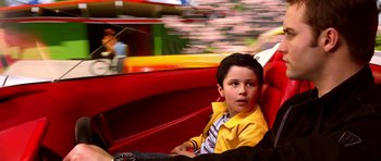 Movie still from “Speed Racer” (2008), directed by Lilly Wachowski – A young boy riding a carnival ride on a ferris wheel; Close Up shot, Over the shoulder angle