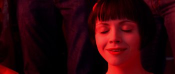 Movie still from “Speed Racer” (2008), directed by Lilly Wachowski – A woman with her eyes closed in a dark room; Close Up shot, Low angle