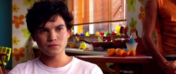 Movie still from “Speed Racer” (2008), directed by Lilly Wachowski – A man sitting in front of a counter with oranges; Close Up shot, Over the shoulder angle