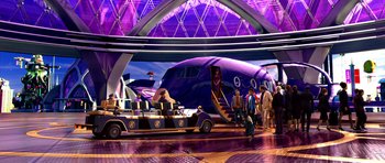 Movie still from “Speed Racer” (2008), directed by Lilly Wachowski – People are walking around a museum with a plane in the background; Extreme Wide shot, High angle