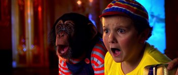 Movie still from “Speed Racer” (2008), directed by Lilly Wachowski – A boy and a monkey are looking at the camera; Close Up shot, Over the shoulder angle
