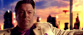 Movie still from “Speed Racer” (2008), directed by Lilly Wachowski – A person wearing a suit and tie; Close Up shot, Over the shoulder angle