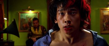 Movie still from “Speed Racer” (2008), directed by Lilly Wachowski – A young man with blood all over his face; Close Up shot, Low angle