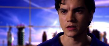 Movie still from “Speed Racer” (2008), directed by Lilly Wachowski – A young man's face in front of a blue sky; Close Up shot, Over the shoulder angle