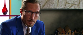 Movie still from “Speed Racer” (2008), directed by Lilly Wachowski – A person wearing a suit and tie; Close Up shot, Over the shoulder angle