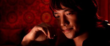 Movie still from “Speed Racer” (2008), directed by Lilly Wachowski – A person with his chin resting on his hand; Close Up shot, High angle