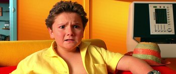 Movie still from “Speed Racer” (2008), directed by Lilly Wachowski – A woman in a yellow button up shirt is crying; Close Up shot, High angle