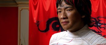 Movie still from “Speed Racer” (2008), directed by Lilly Wachowski – A person wearing a white shirt; Close Up shot, Low angle