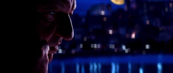 Movie still from “Speed Racer” (2008), directed by Lilly Wachowski – A man's face in front of a city skyline at night; Close Up shot, Low angle