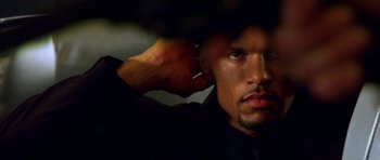 Movie still from “Speed Racer” (2008), directed by Lilly Wachowski – A person with his hand on his head; Close Up shot, Low angle