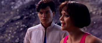 Movie still from “Speed Racer” (2008), directed by Lilly Wachowski – A man and a woman standing next to each other; Close Up shot, Over the shoulder angle