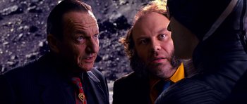 Movie still from “Speed Racer” (2008), directed by Lilly Wachowski – A couple of men standing next to each other; Close Up shot, Over the shoulder angle