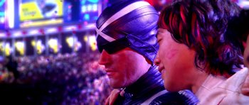 Movie still from “Speed Racer” (2008), directed by Lilly Wachowski – A man wearing a helmet and a leather jacket; Close Up shot, Over the shoulder angle