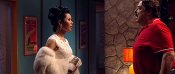 Movie still from “Speed Racer” (2008), directed by Lilly Wachowski – A woman in a white dress holding a purse; Medium shot, Over the shoulder angle