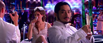 Movie still from “Speed Racer” (2008), directed by Lilly Wachowski – A man and a woman sitting in front of each other; Medium shot, Over the shoulder angle